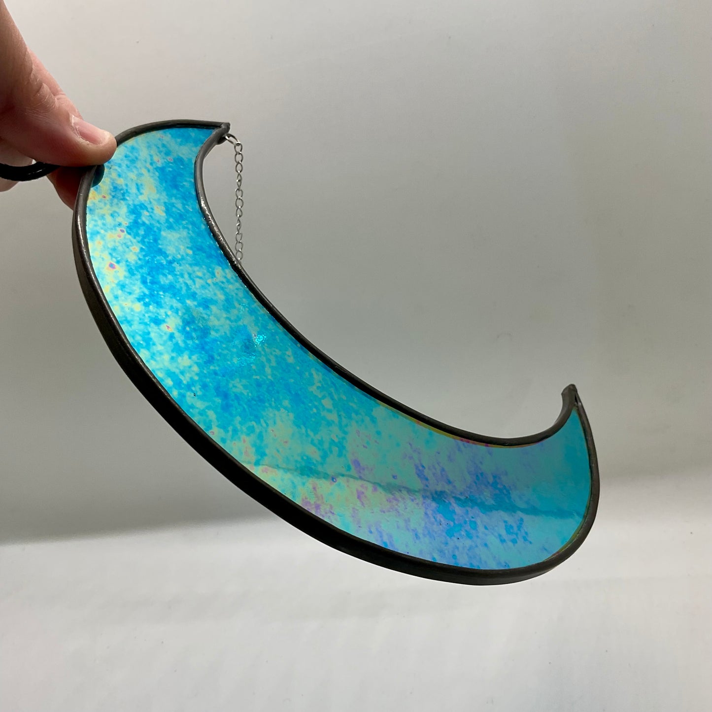 Iridescent crescent moon with dichroic star gem