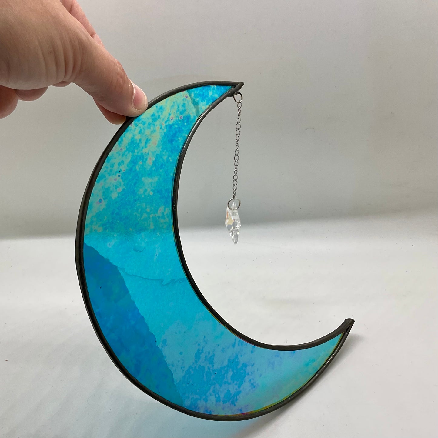 Iridescent crescent moon with dichroic star gem