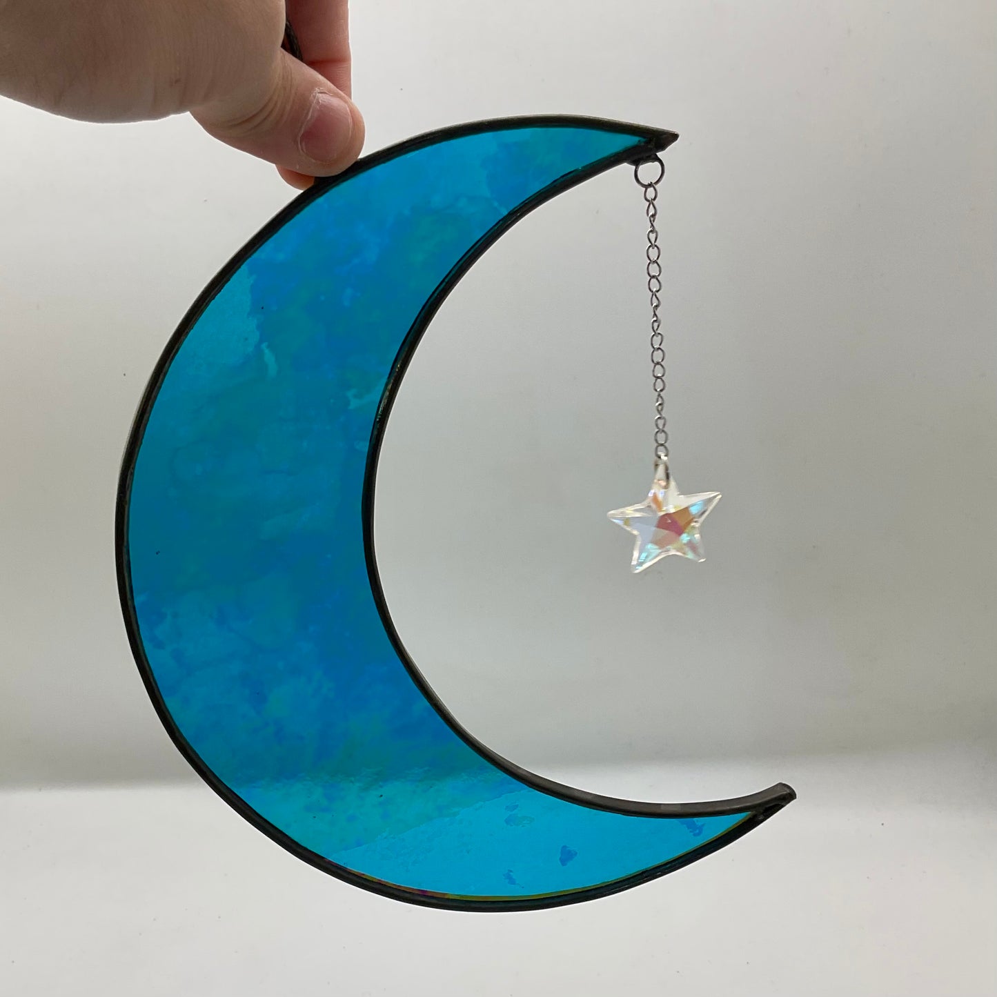 Iridescent crescent moon with dichroic star gem